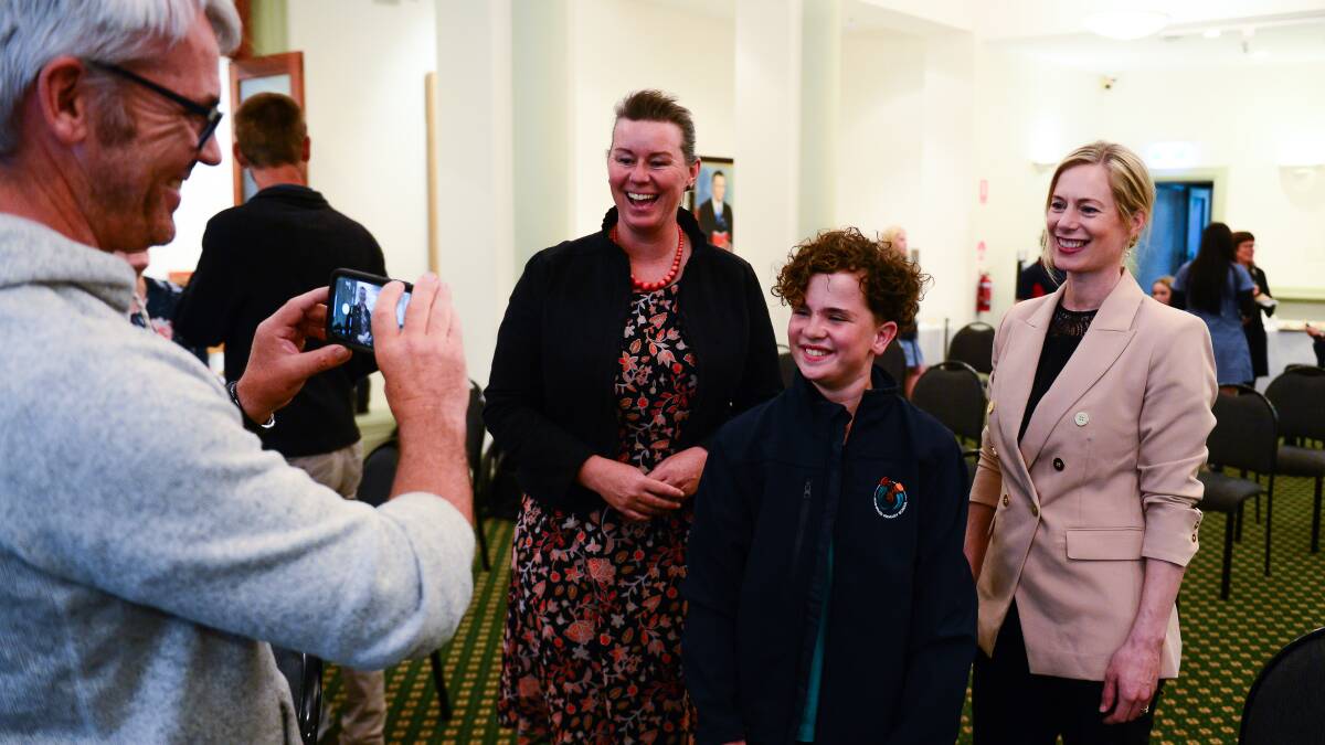 Reconciliation: James Clark photographs his son Norwood Primary School pupil Samuel Clark, with Bass Labor MHA Janie Finlay and Labor leader Rebecca White at the Youth Speak Out. Pictures: Chris Crerar 