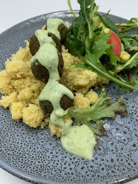 Falafels with herb yoghurt dressing, cous couse and garden salad. An example of one of the hot lunch dishes being served up to Tasmanian students.