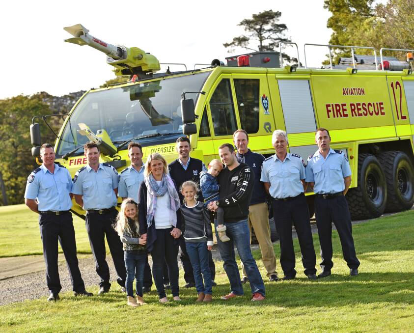 BANDING TOGETHER: Alexis, 5, Yvette, Georgia, 7, Pippa, 3, and David Harmey with members of Aviation Rescue and Firefighting C Crew and the Launceston Golf Club. Picture: Scott Gelston.