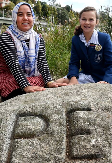 PEACE: TasTafe's Shukria Hussain with Launceston Church Grammar School's Isabel Brown at the Peter Underwood Peace Garden. Picture: Neil Richardson.