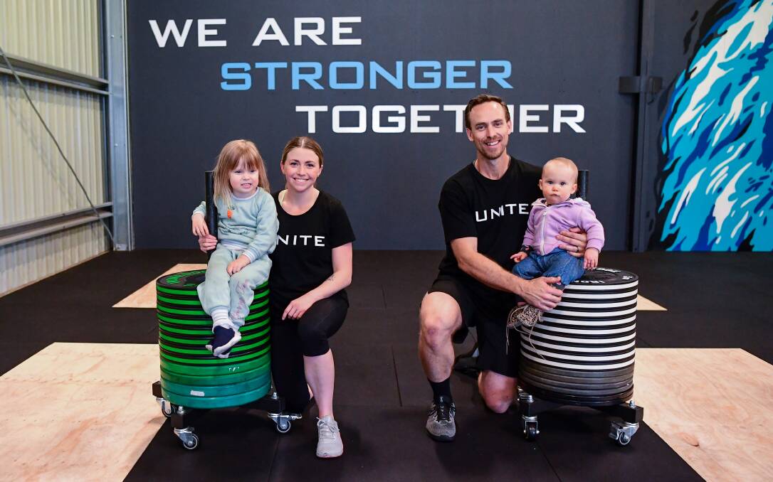 Family first: Haylee and Matt Cocker with daughters Isla (3) and Marlee (10 months) at the Waverley gym. Picture: Neil Richardson