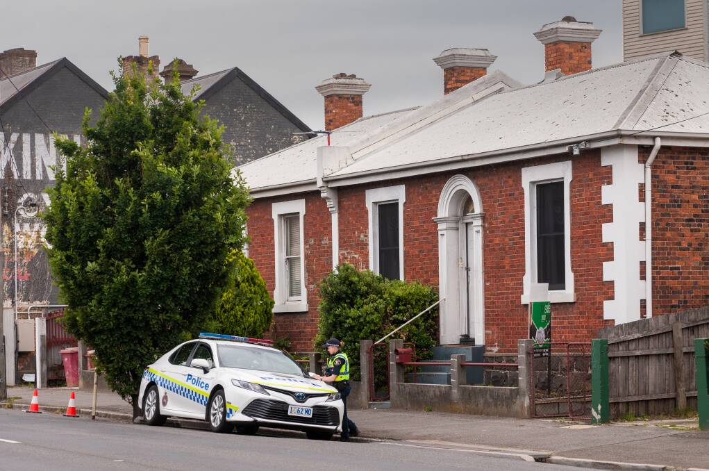 Murder scene: Police investigate at a Wellington Street residence on Sunday morning. Picture: Phillip Biggs