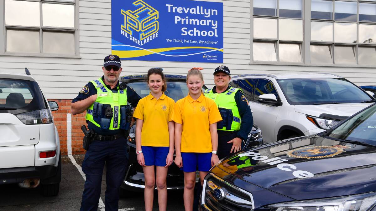 Holiday ready: Trevallyn Primary School pupils Ava and Lilly, pictured with Constable Michael Poxon and Constable Sandy Watkins, are excited to start holidays. Photo: Neil Richardson