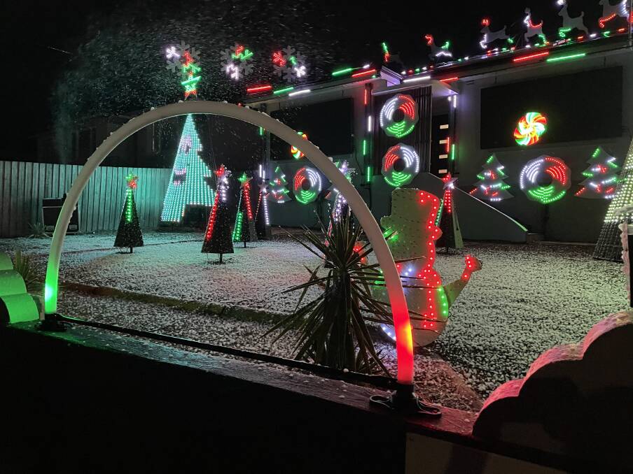 The Christmas display lit up - with snow machine in use. Picture: Max Jago 