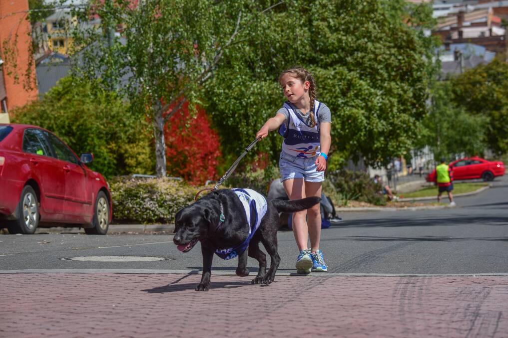 Feeling the burn: Eight-year-old Annie Burnett and dog Jedda at the top of the hill. Picture: Paul Scambler
