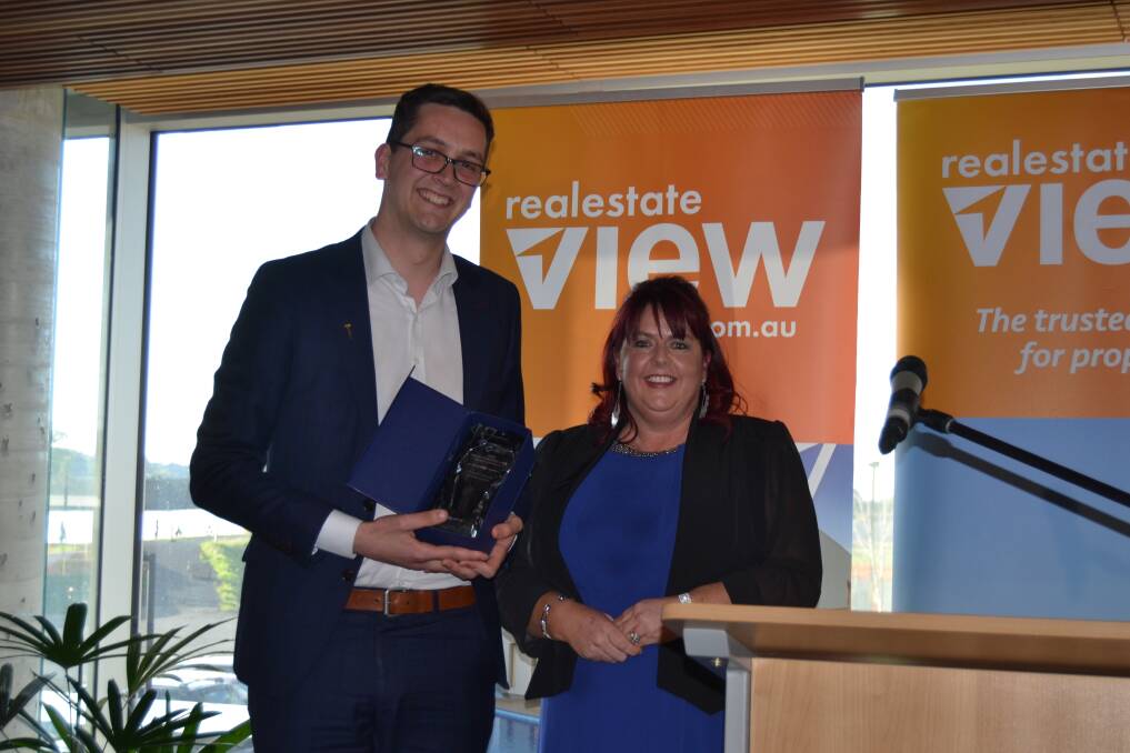 Winners are grinners: Conall Cassidy from Harcourts Launceston with Mandy Welling, REIT president. Picture: Ebony Abblitt.