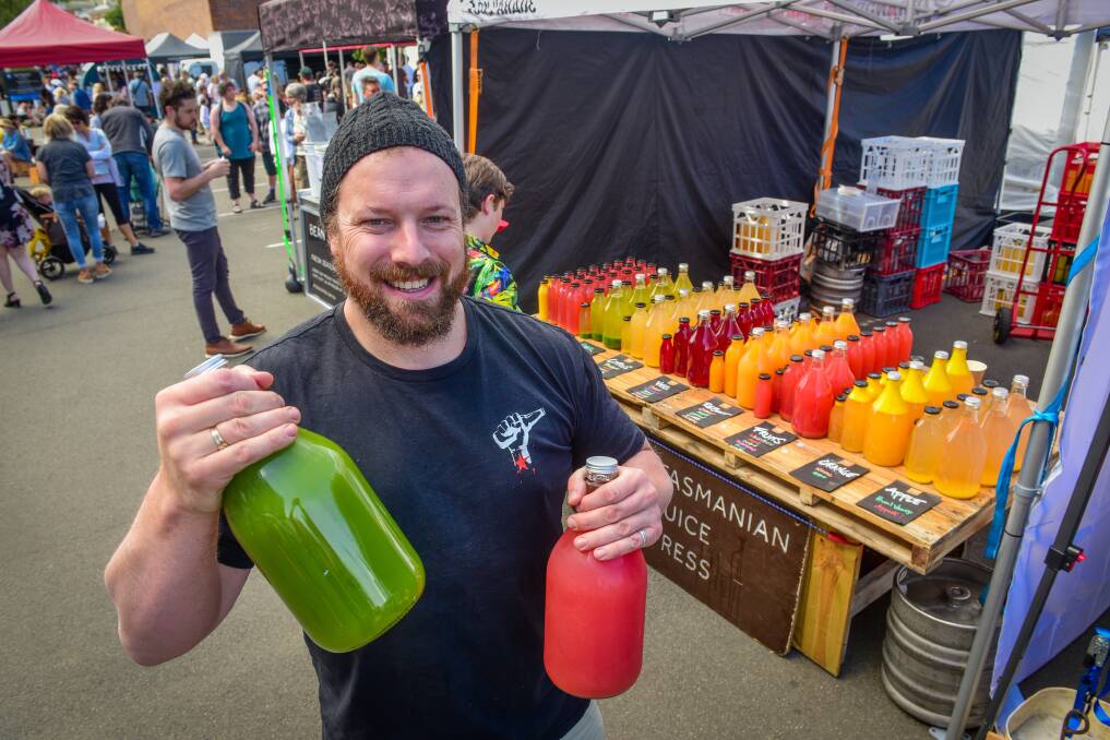 New home: Tasmanian Juice Press co-owner Bentley Deegan at their Harvest stall. Picture: Paul Scambler