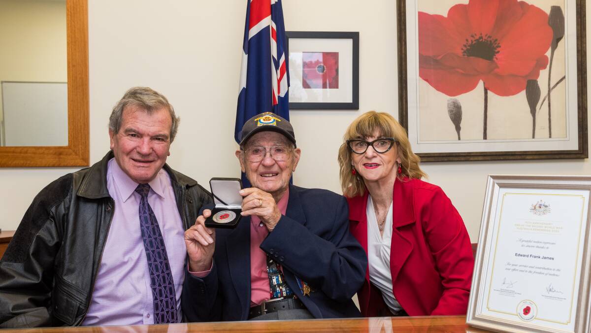 Medal of Honour: WWII veteran Edward 'Ted' James (centre) with son Alan James and Senator Helen Polley. Picture: Phillip Biggs
