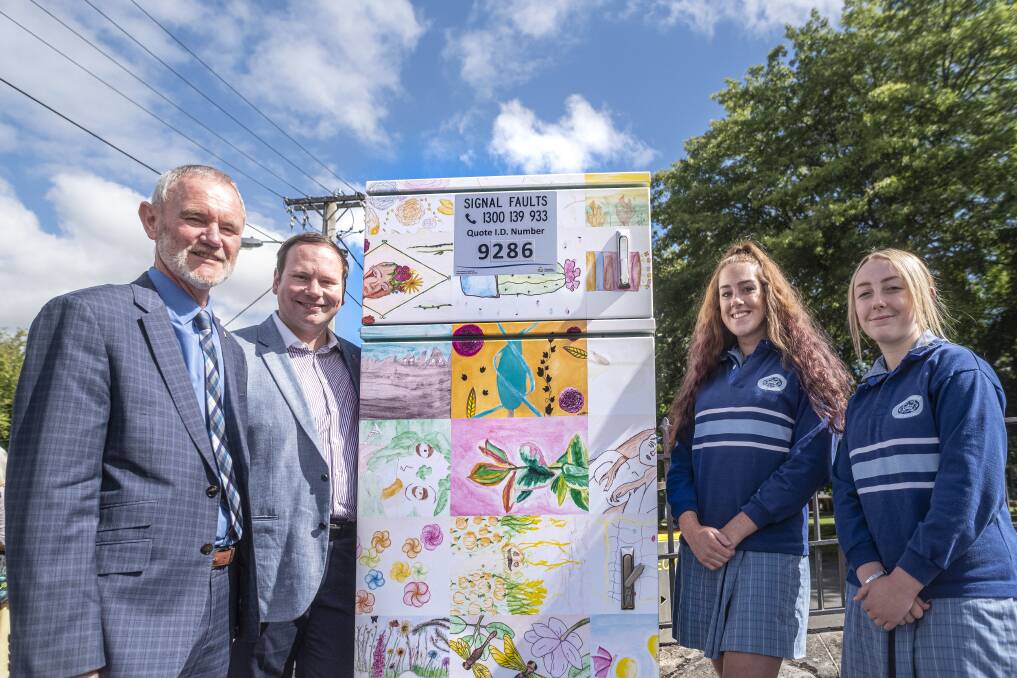 ON DISPLAY: Launceston Mayor Albert van Zetten and Deputy Mayor Danny Gibson with Kings Meadows High School students Grace Richardson and Ashtyn Peters in front of one of the decorated boxes. Picture: Craig George
