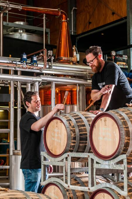 Tapping in: Justin Turner and distiller Brett Coulson inspect whisky barrels