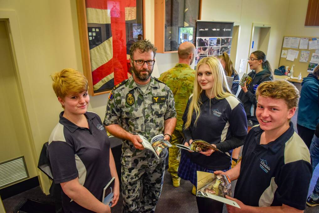 Learning: Lilydale District High students Sarah Torster, Savannah Ainslie and Jack Flynn with Petty Officer Daniel McRoe. Picture: Paul Scambler