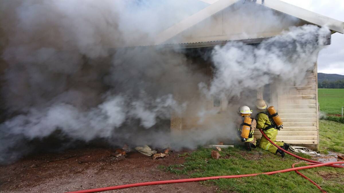 Tasmania Fire Service crew fight a fire at Montumana Road on Thursday.