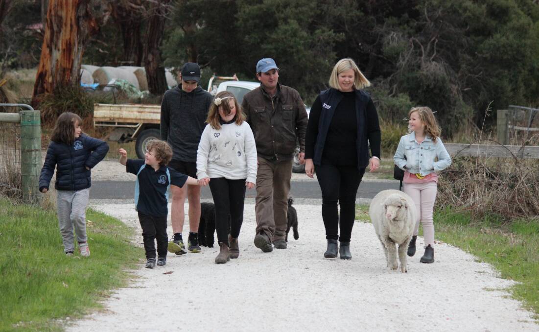 FAMILY TIME: Bridget Archer enjoys quality time with her husband and kids - and a sheep - on their farm outside of George Town. L-R: Molly, 6, James, 4, Luke, 15, Lauren, 10, husband Winston and Edith, 8. Picture: Supplied