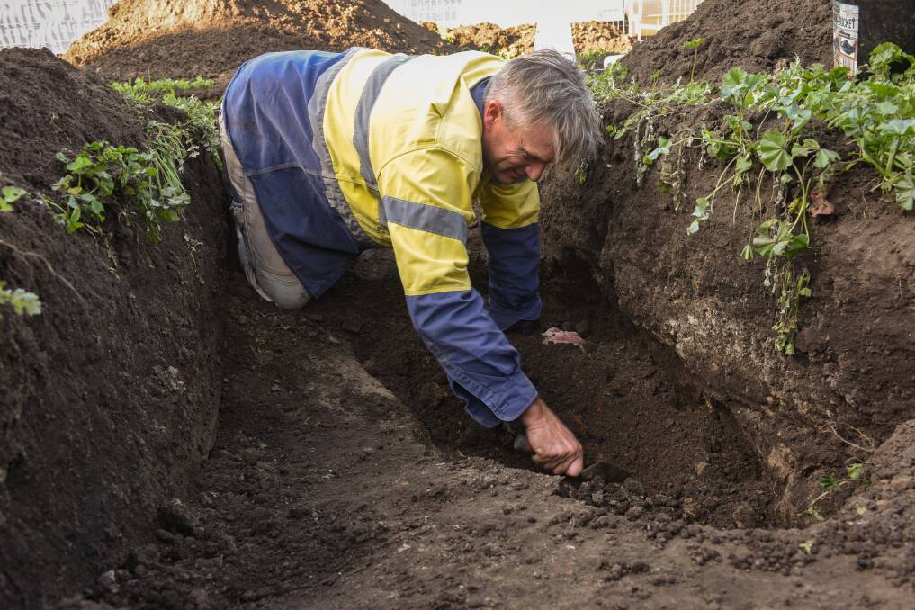 TRAWLING FOR TREASURES: Southern Archaeology's Darren Watton and his team have spent the week unearthing artefacts from an inner-city block of land. Plans are in motion to build a pair of distinctive townhouses on the site. Picture: Paul Scambler