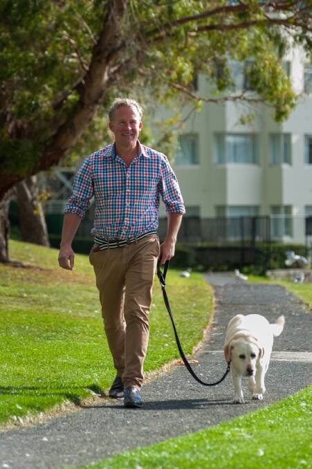 Hodgman taking his dog Maisie for a walk in their home suburb of Sandy Bay. Picture: Phillip Biggs