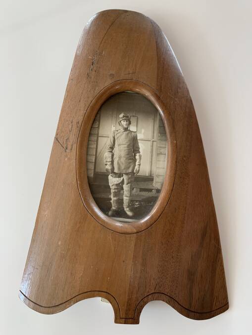 Guy Barnetts grandfather Stan Barnett. The picture frame is made from the wood from the propeller of Stan's plane. Picture: Supplied