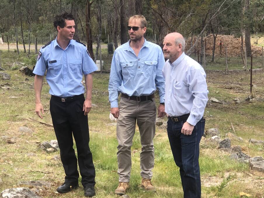 Police, Fire and Emergency Management Minister Mark Shelton (right) with the Tasmania Fire Service's Bradley Williams (left) and the Tasmanian Farmers and Graziers Association's John Atkinson (centre) at the site of a recent fuel reduction burn at Karoola. Picture: Rob Inglis