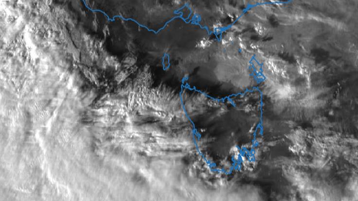 A frontal cloud band moving over Tasmania. Smoke from the Victorian bushfires is expected to persist in Tasmania until a westerly change later this afternoon. Picture: Bureau of Meteorology