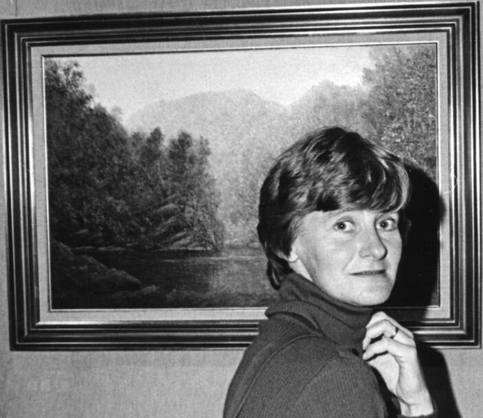PORTRAIT OF THE ARTIST: Val Whatley with one of her paintings, circa 1980s. Picture: Supplied