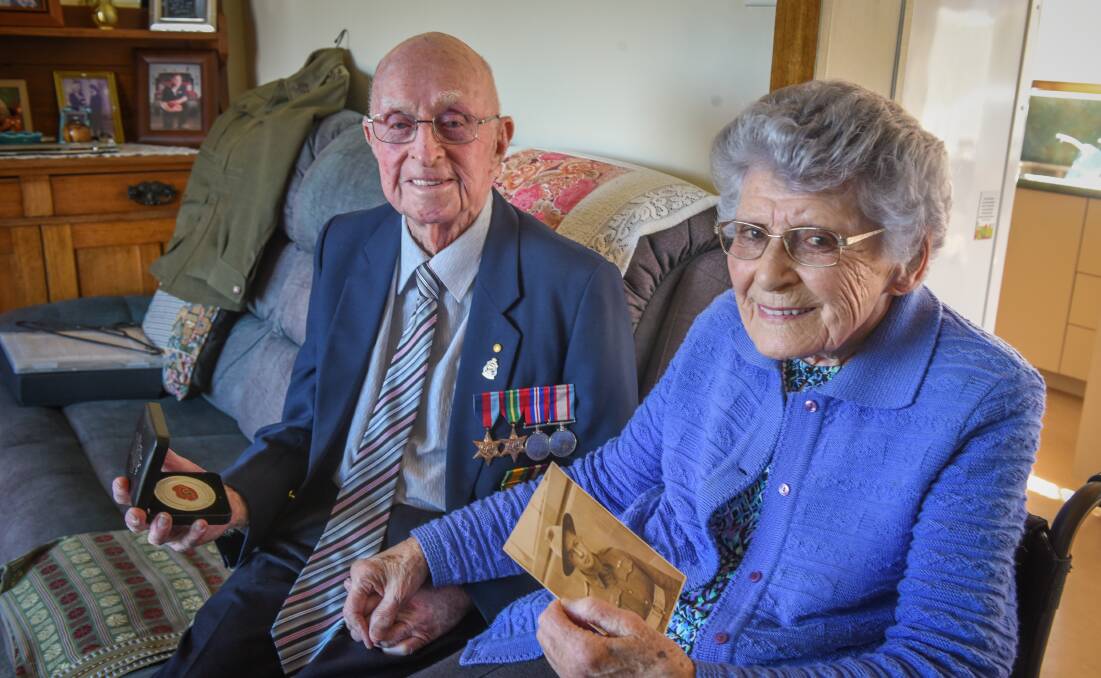 LOVING COUPLE: Pat Clements and his wife Alma, pictured holding a photo of her husband, have been honoured by the West Tamar Council. Picture: Paul Scambler