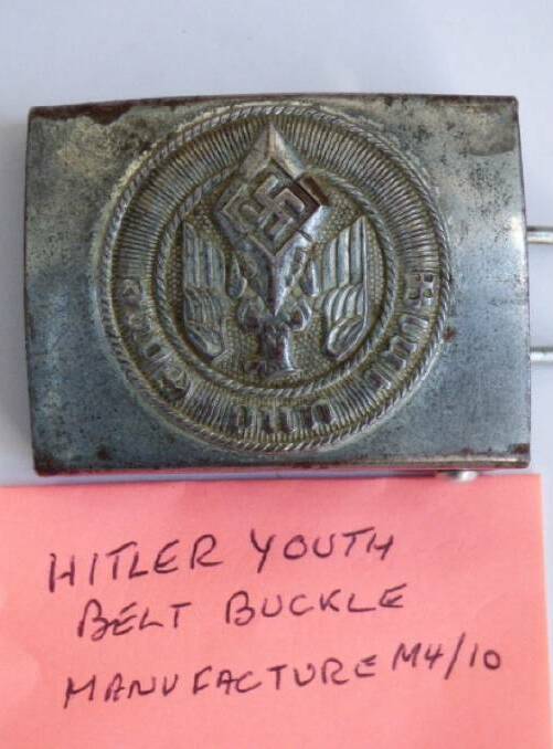 A Hitler Youth belt buckle is among the items of Nazi memorabilia that will be up for sale at a Launceston auction house this Wednesday. Picture: Armitage Auctions