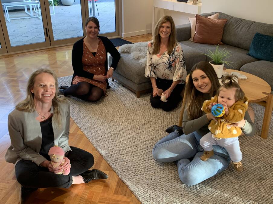 Health Minister Sarah Courtney enjoys some down time with expectant mum Sarah Brooks, doula Krista McCrimmon and Laura Wilson and daughter Isla Wiggers, 1.