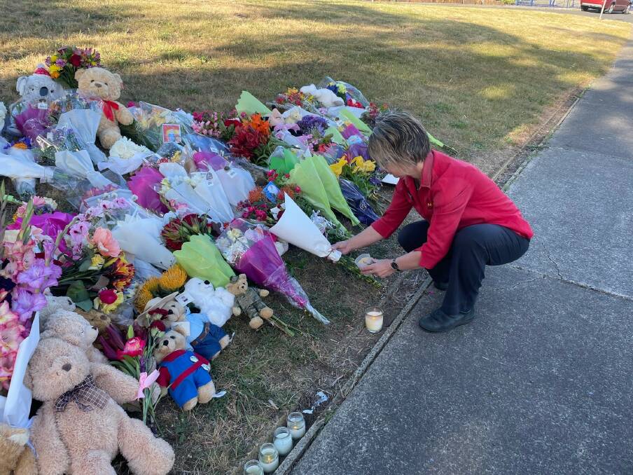 Showing Support: Devonport mother Melissa places flowers and a candle at the growing tribute outside Hillcrest Primary School. Picture: Libby Bingham.