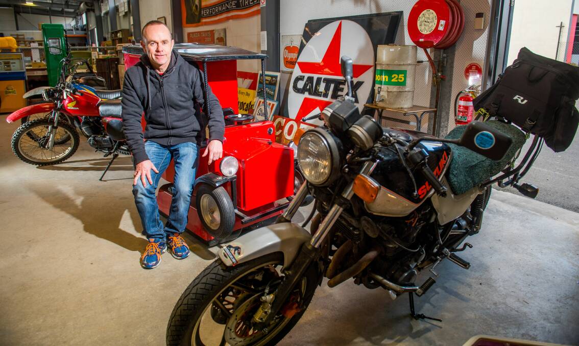 HAMMER TIME: Armitage Auctions' Neil O'Brien with a coin-operated childrens' ride at the petrol memorabilia auction. Picture: Scott Gelston