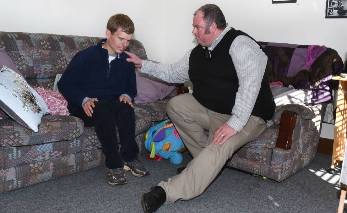 UNCERTAIN: Giant Steps' Next Steps student, Charles, sits with principal Tim Chugg. Charles will be one of 13 people affected by the closure. Picture: Neil Richardson 