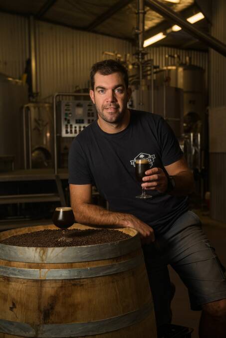 STOUT: Van Dieman Brewing head brewer Will Tatchell raises a glass of his new After Dinner Mint creation. Picture: Scott Gelston 