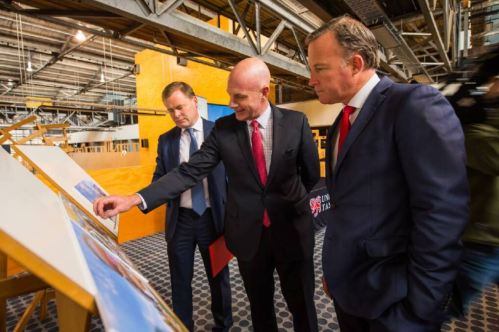 BOOST: University of Tasmania vice-chancellor Peter Rathjen, Treasurer Peter Gutwein and Premier Will Hodgman inspect conceptual images. Picture: Scott Gelston 
