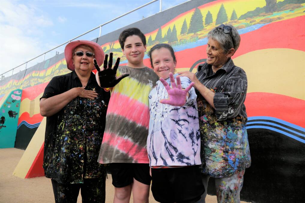 Aboriginal elders and artists Judith-Rose Thomas and Nannette Shaw with Riverside Olympic FC juniors Jack Campbell, 13, and Katie Campbell, 11 - ready to make their mark on the Riverbend Park mural. Picture: Matt Dennien