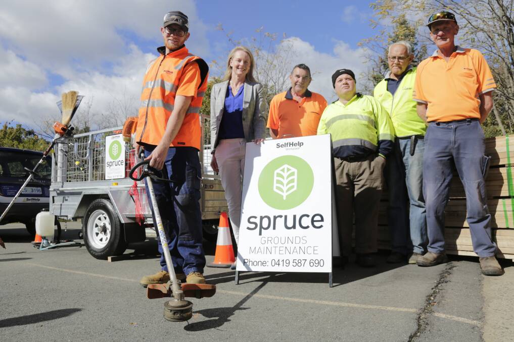 Kyle Thompson readies his whipper snipper with Sarah Courtney and other members of the Spruce Grounds Maintenance team - Self Help Workplace's latest venture. Picture: Matt Dennien 