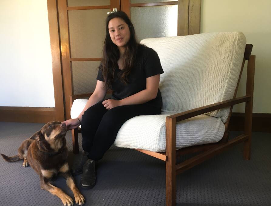 BUILDING FUTURES: Chanelle Lum and her eight-year-old kelpie Ruby on the floating sofa designed and made under her furniture brand, Two Woods. Pictures: Supplied