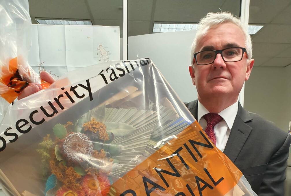 Independent Clark MHR Andrew Wilkie with a quarantined floral arrangement mailed to him by Facebook. Picture: Supplied
