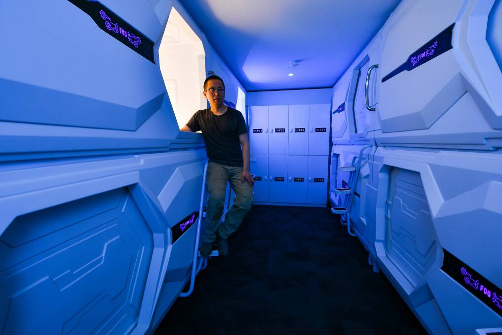 COSY: Co owner Zach Fu looks at the sleeping pods at Pod Inn, Launceston's new accommodation on Wellington Street. Picture: Scott Gelston 