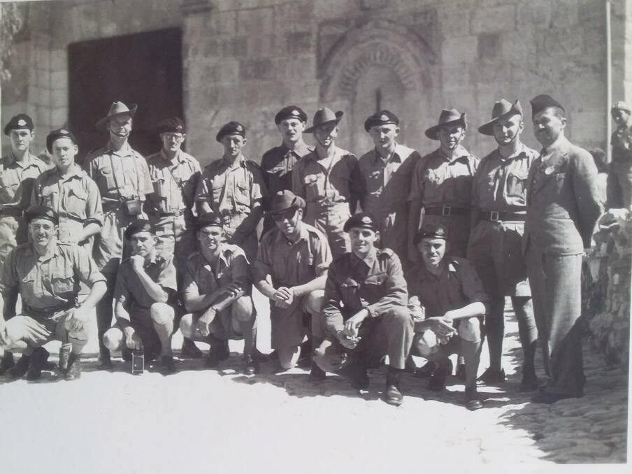 Frank Rigney, third from left, stands in the back row with colleagues somewhere in the Middle East during his four-year service with the Australian Army during World War II.