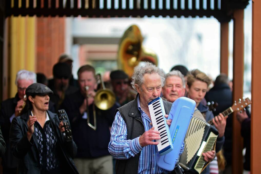 JAZZ LANDS: Don Ives with the melodica leads a procession along Wellington Street, Longford as part of the 2016 festival. Picture: Phillip Biggs