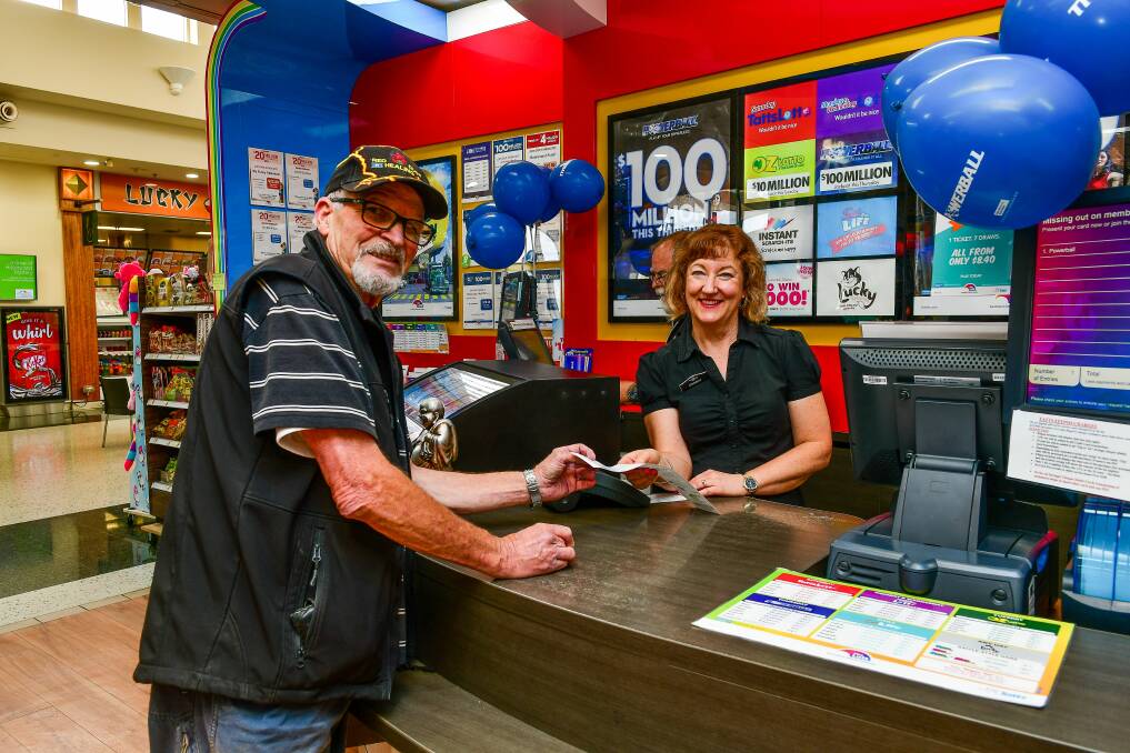 IN WITH A SHOT: Prospect Marketplace News' Christine Henderson gives Murray Everett his ticket in Thursday's $100 million Powerballl draw, the equal highest jackpot in its history. Picture: Scott Gelston