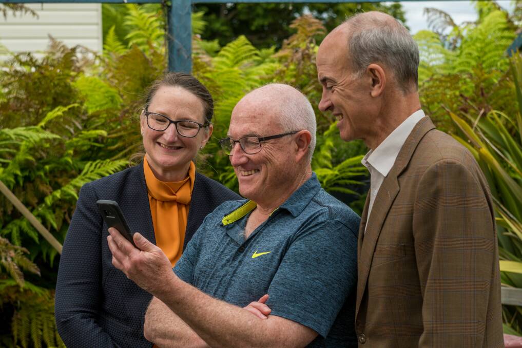 UPDATING: Aurora Energy chief executive Rebecca Kardos and Mowbray PAYG+ trial participant Malcolm Liehr with Energy Einister Guy Barnett. Picture: Phillip Biggs 