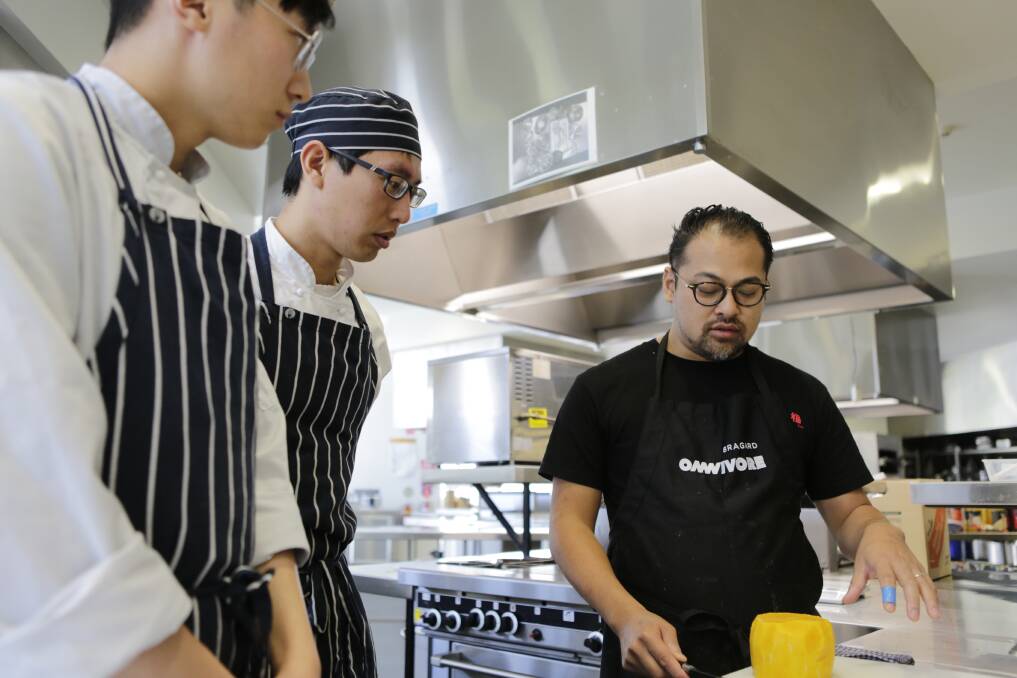 COOKING: Drysdale students Will Wang and Wei Chih Shih with chef Jowett Yu ahead of Restaurant Tasmania event. Picture: Matt Dennien