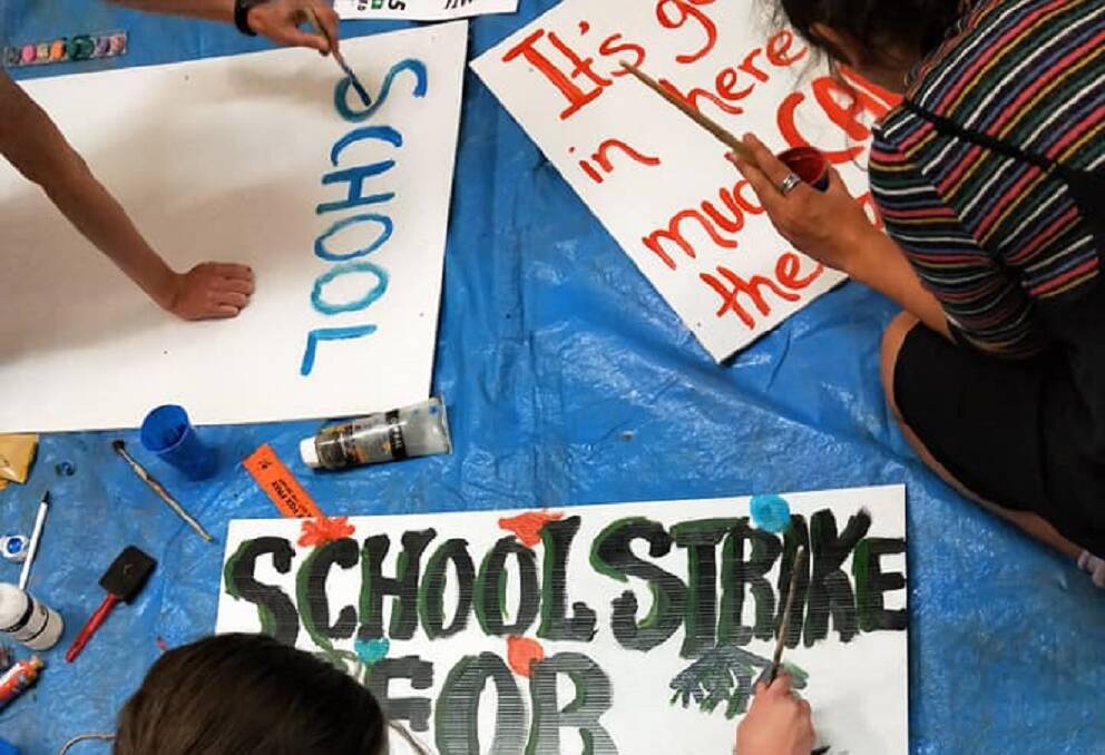 Students make signs for the Launceston School Strike 4 Climate rally. Picture: Supplied