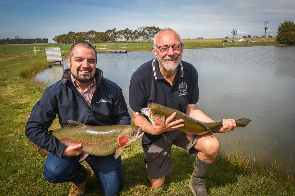 FISHING: Petuna freshwater operations manager Rene Contreras and committee member Dennis Betts with fish for the Tasmanian Trout Expo. Picture: Paul Scambler