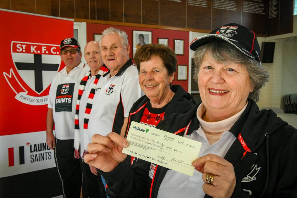 SAINTS: Greg Adams, Bev Catlin and Dianne Jones of the Launceston Saints with a $500 cheque for the Examiner Winter Relief Appeal. Picture: Paul Scambler