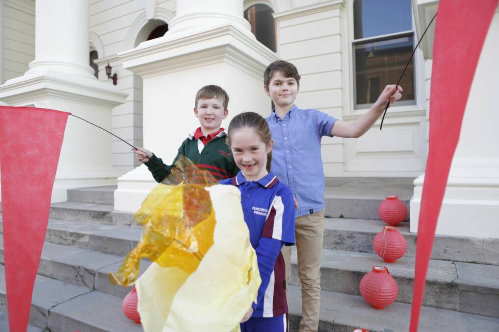 PREPARING: Callum Wright, 8, Kate Hind, 6, and Charlie Beswick, 10, ready their decorations for Saturday's lantern walk and solstice event. Picture: Matt Dennien