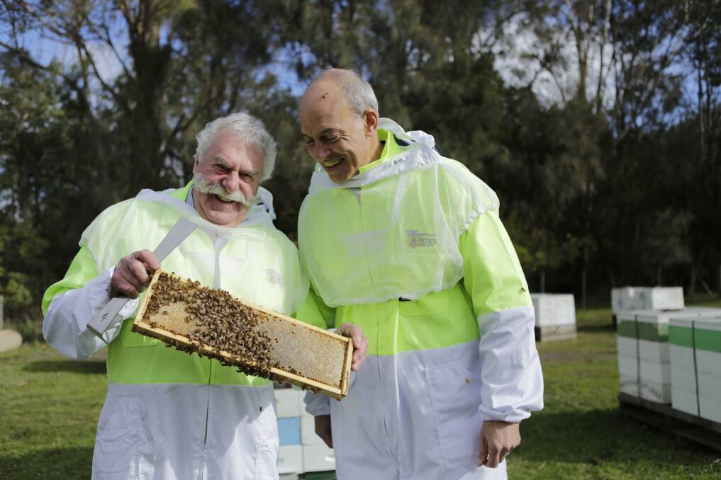 BUZZING: Tasmanian Beekeepers Association president Lindsay Burke with Primary Industries Minister Guy Barnett on Sunday. Picture: Matt Dennien