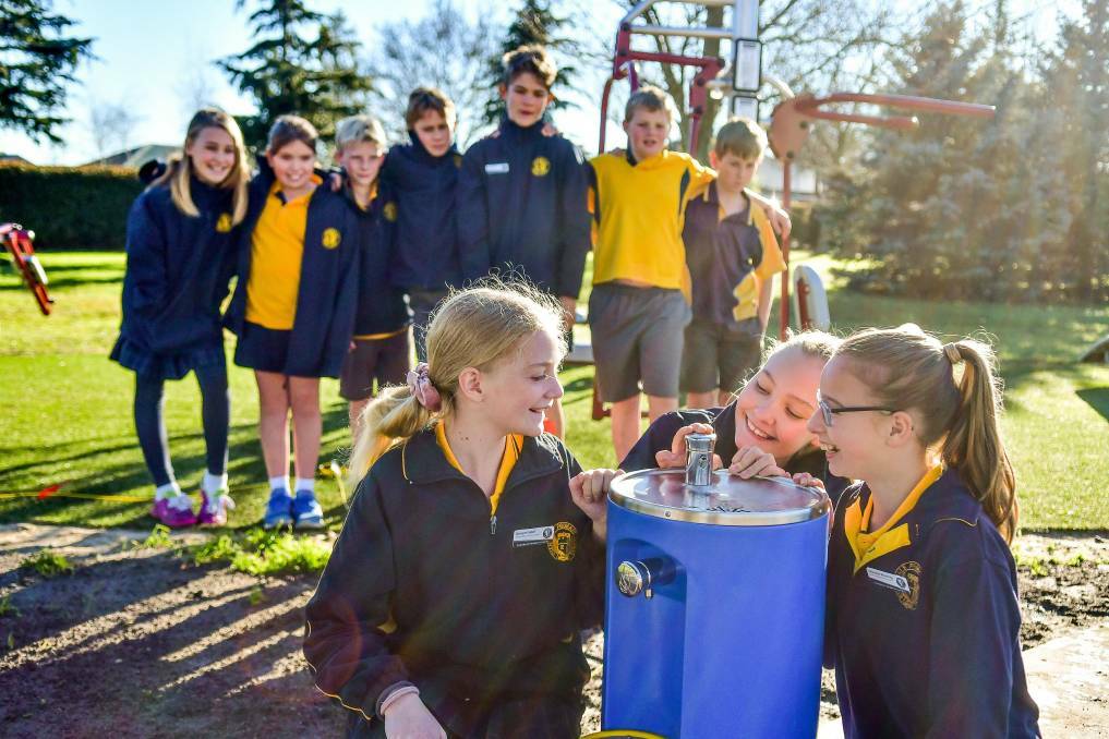 BUBBLING: Evandale Junior Action Group members Georgie Gabel, Breeanna Farrel and Charlotte Brunning with the drinking fountain at Morven Park. Picture: Scott Gelston