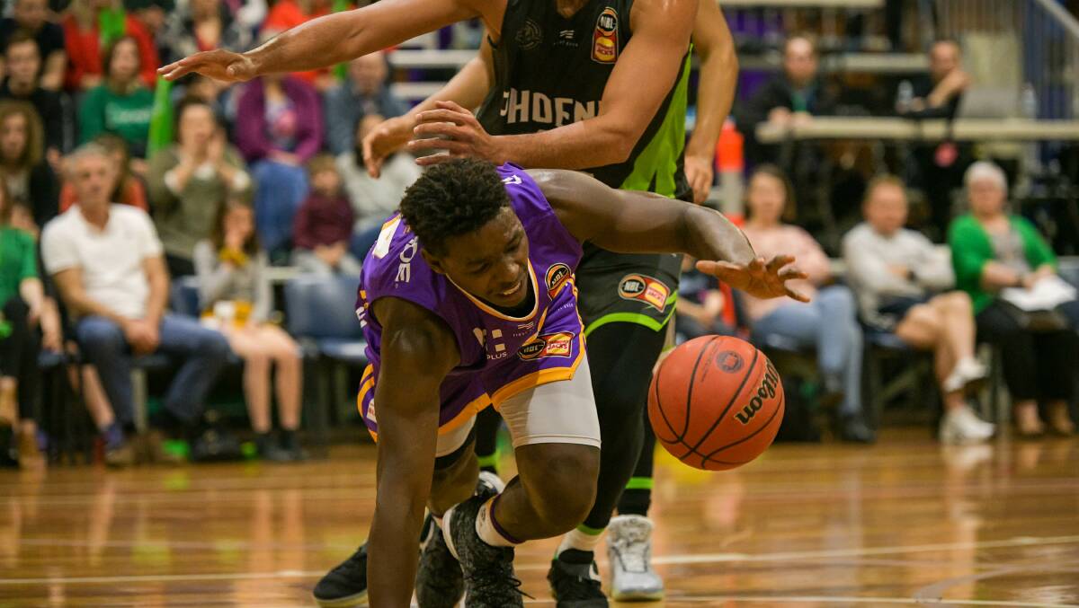 HOLDING ON: Jae'Sean Tate desperately tries to keep possession during the NBL Blitz match at the Devonport Recreation Centre. Picture: Simon Sturzaker