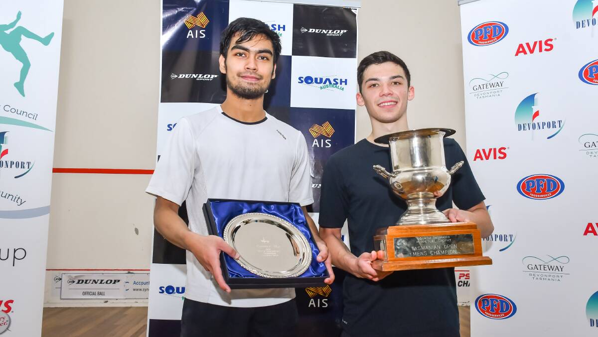 Tournament presentation: Runner-up Mohd Syafiq Kamal and champion Victor Crouin show off their trophies after the City of Devonport Tasmanian Open final on Sunday. Picture: Simon Sturzaker.