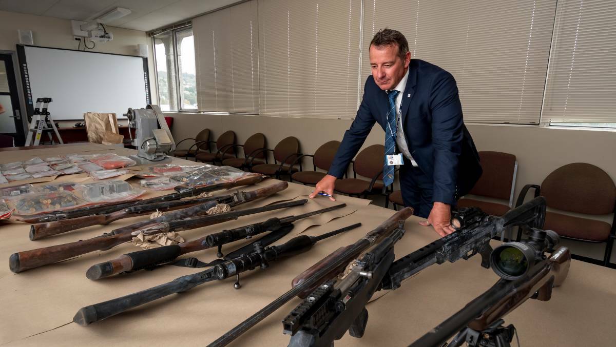 Detective Inspector Craig Fox with firearms seized in Northern Tasmania 